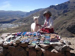 Girl with lama selling souvenirs