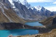 Hiking past snowcapped mountains and lakes